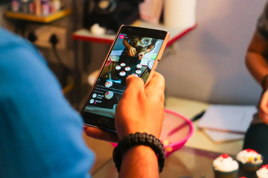 person on phone streaming cupcake decorating 2026 03 09 05 39 21 utc